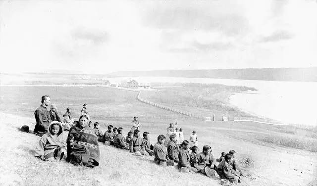 Students and staff of the Fort Qu'Appelle Indian Industrial School on a hillside above the valley